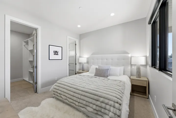 Plush carpeting and a built-in closet system enhance this spacious bedroom