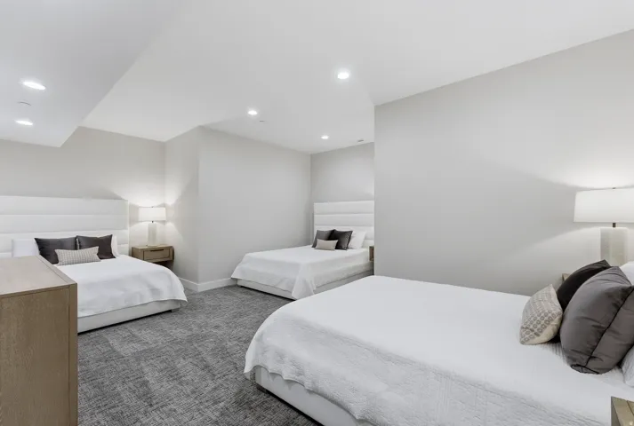 Spacious bedroom featuring recessed lighting and plush patterned carpeting