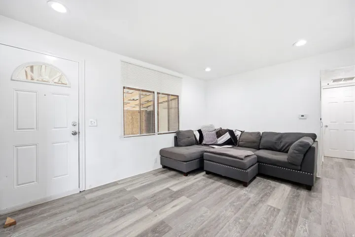 Bright interior space featuring light wood-finish flooring, white walls, and recessed lighting
