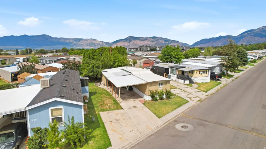 Single-story residence featuring an attached carport and a paved driveway