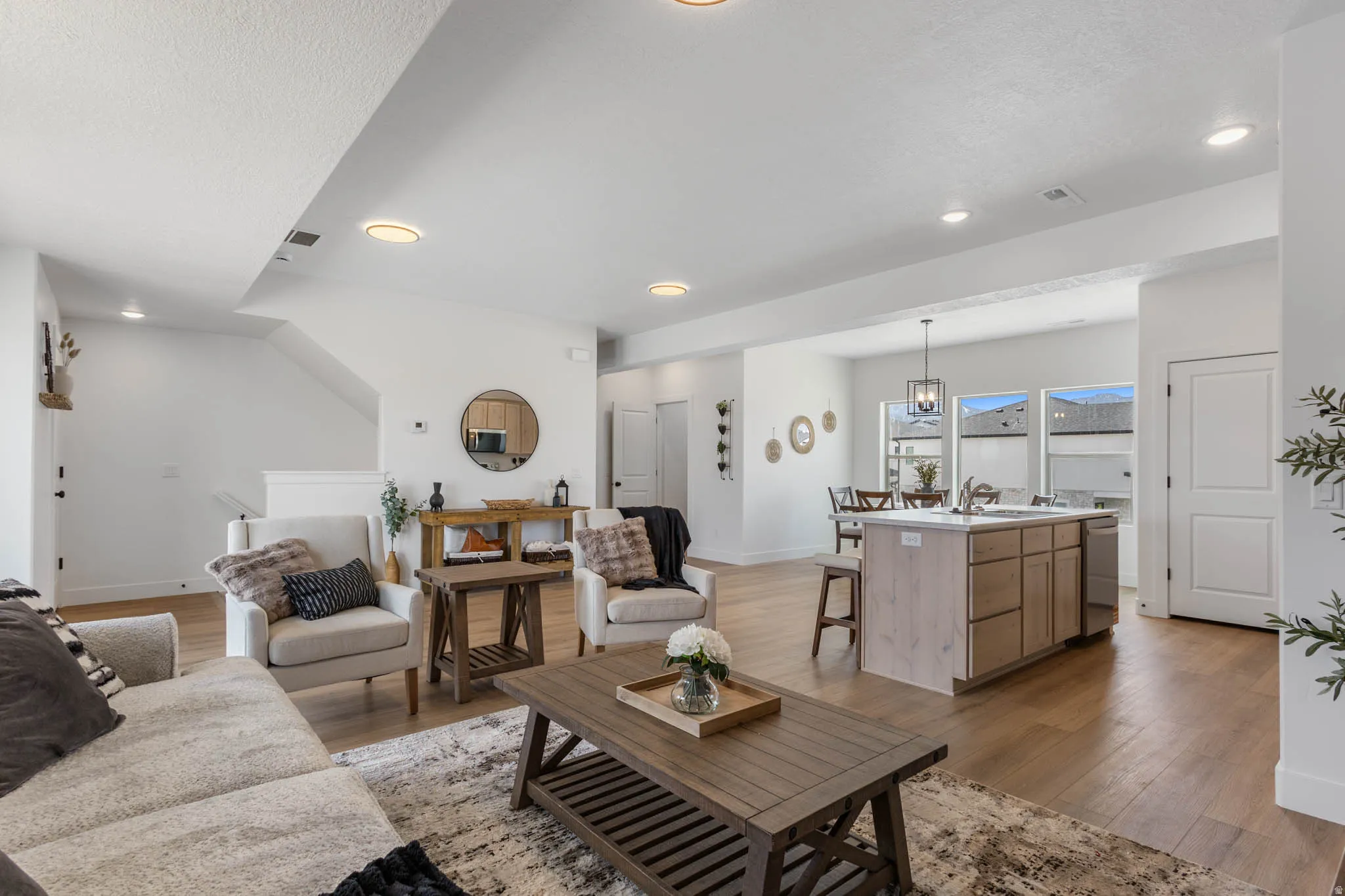 Open-concept living area featuring light wood-finish flooring throughout