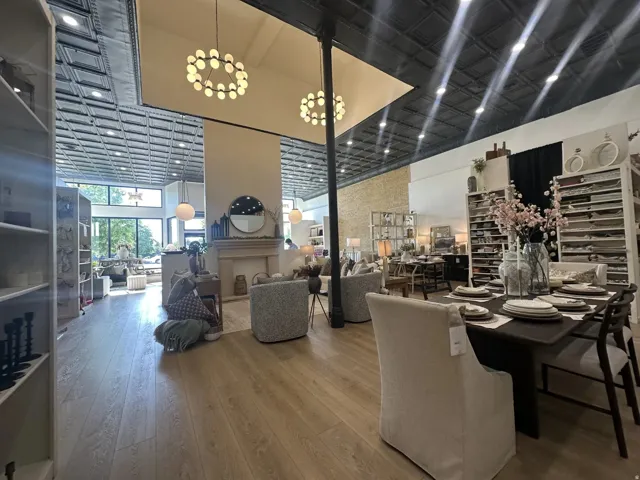 Spacious interior featuring light wood-finish flooring and a black pressed-tin ceiling