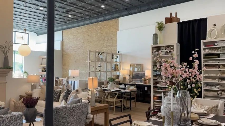 Open concept interior with high ceilings and a detailed ceiling tile pattern