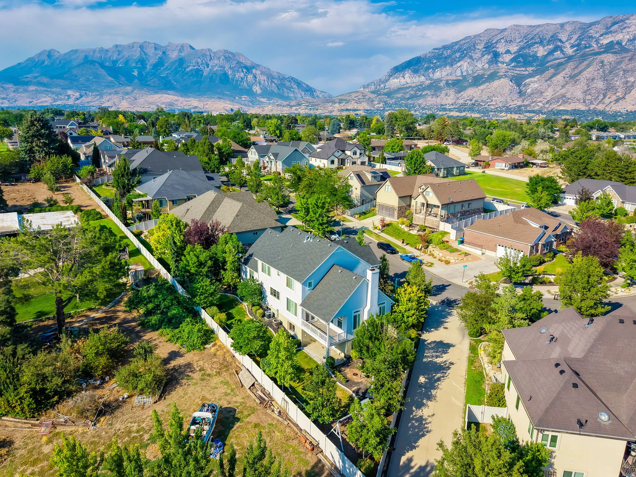 Aerial perspective showcasing a residential area with varied housing styles and mature landscaping