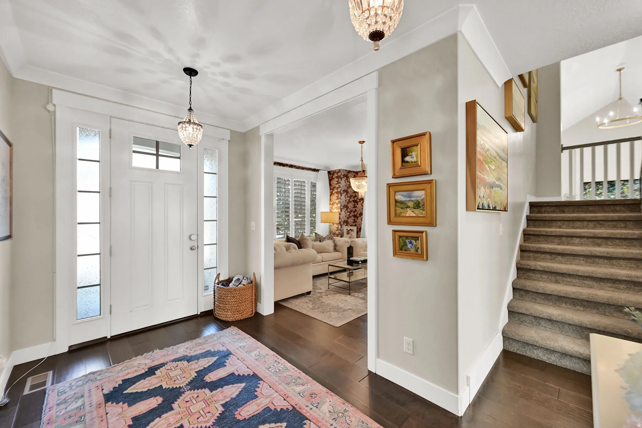Inviting entryway featuring a white paneled door with frosted sidelights and transom window