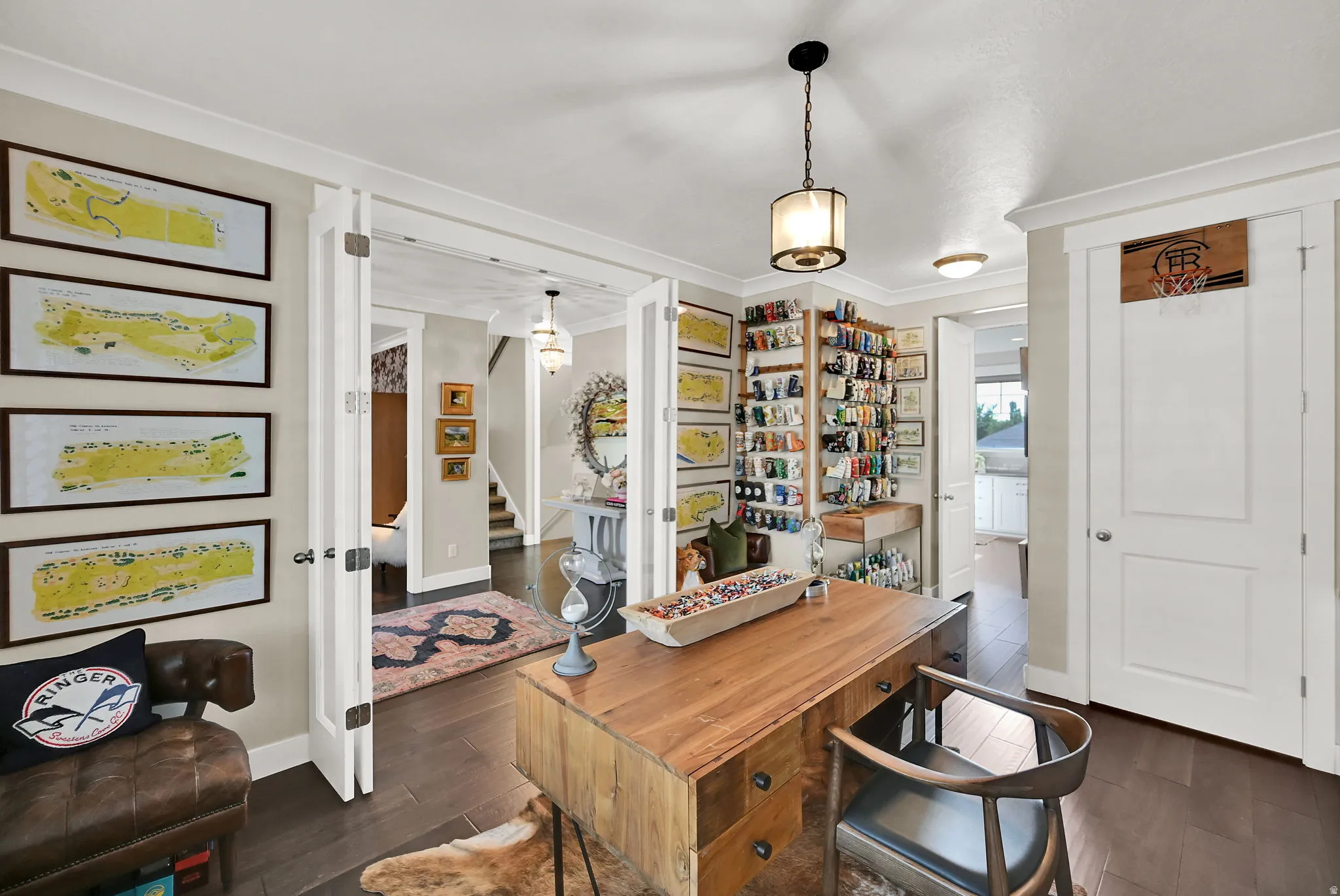 Office space featuring dark wood-finish flooring, light neutral wall tones, and white trim