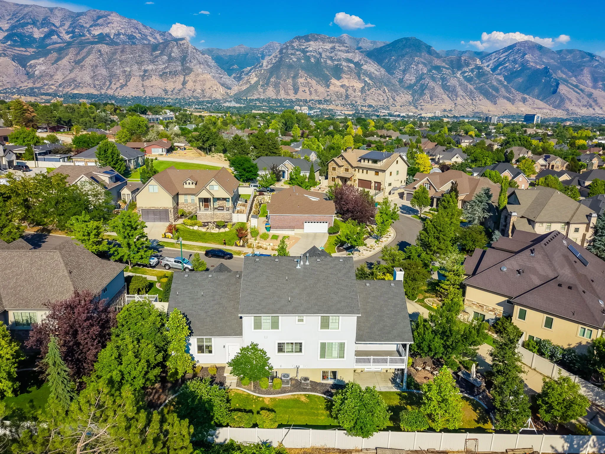 Expansive residential neighborhood with mature trees and a mountain backdrop
