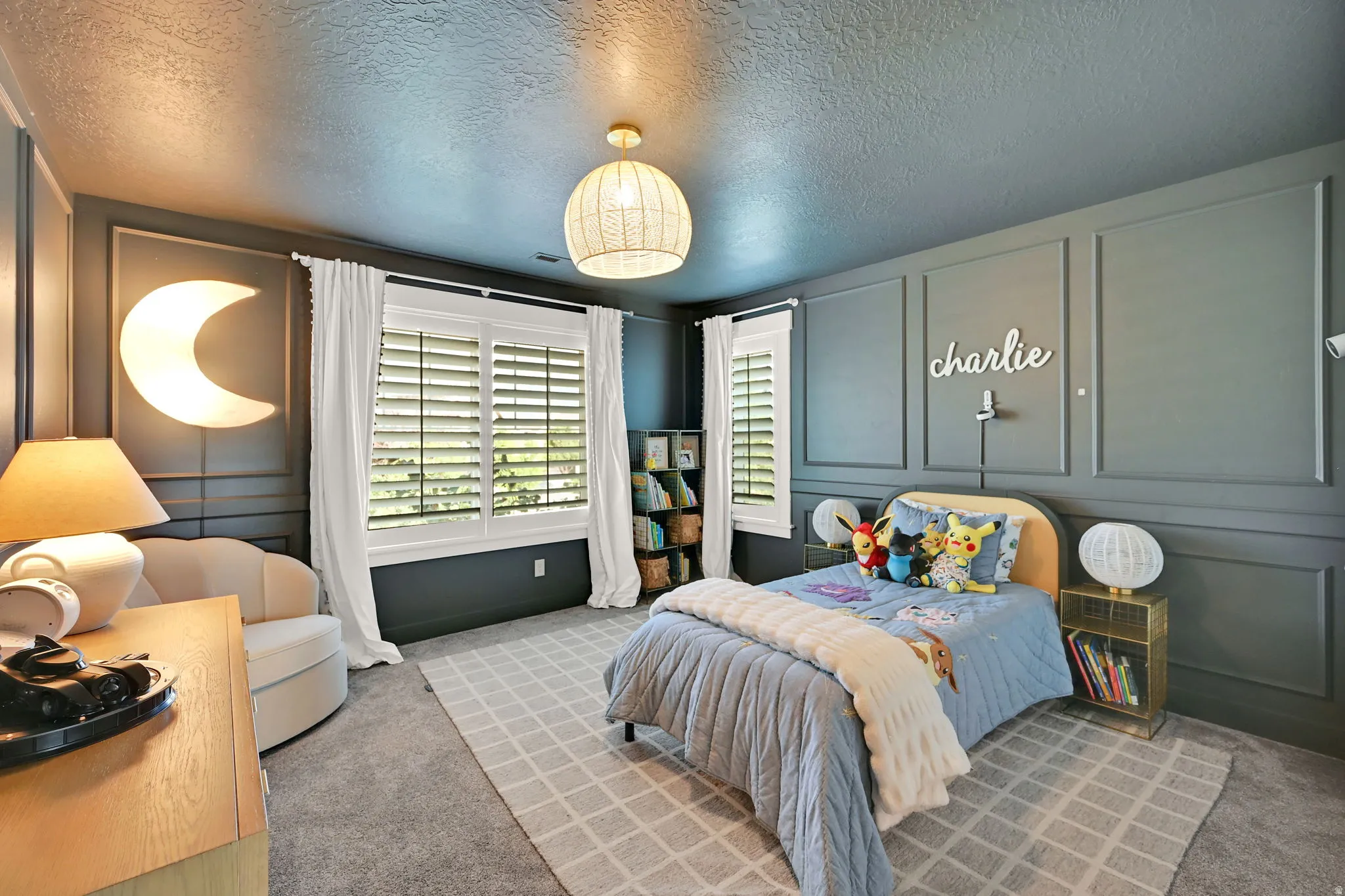 Well-appointed room featuring detailed wainscoting and a textured ceiling