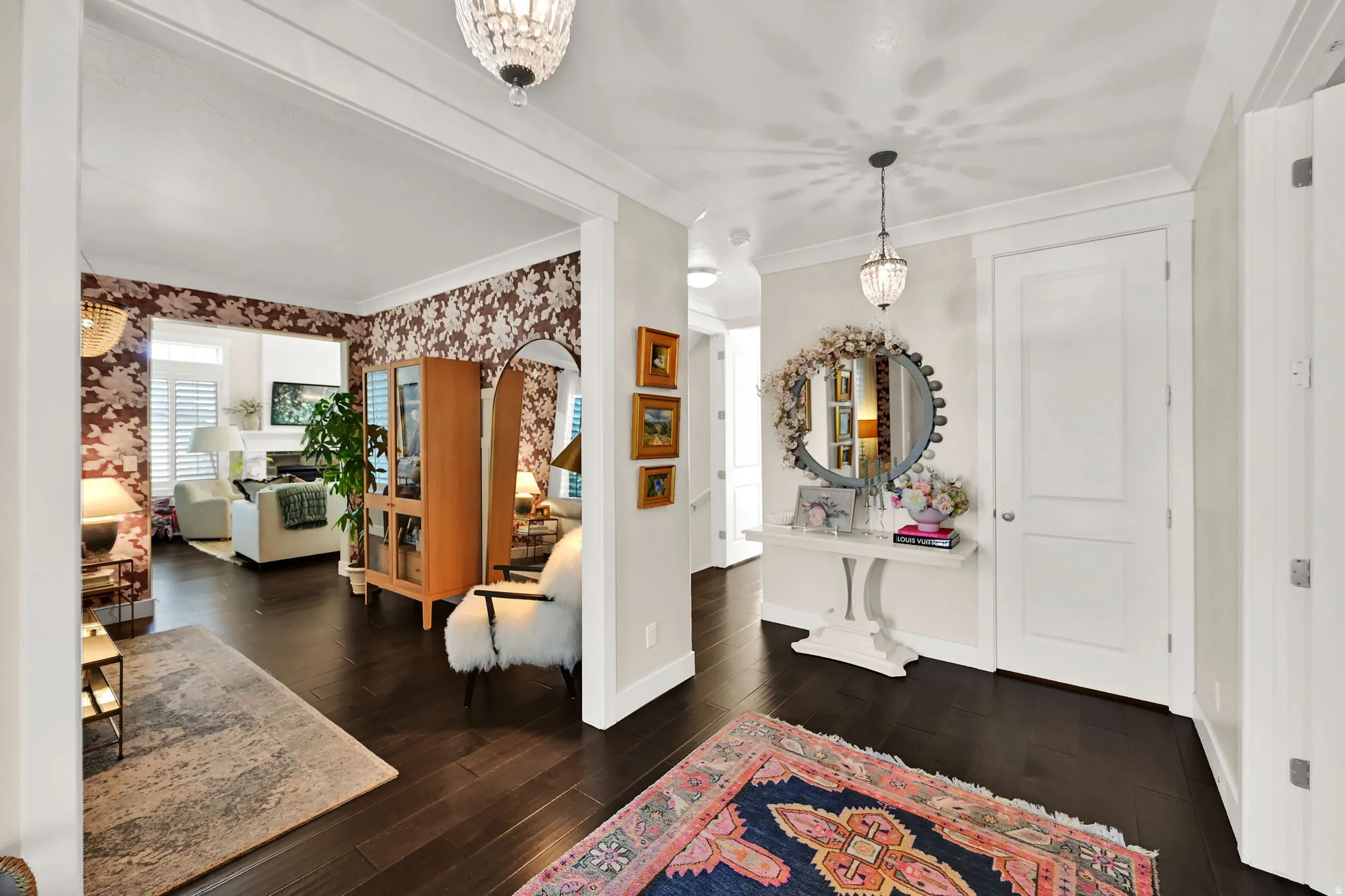 Grand entryway featuring dark wood-finish flooring, two-panel interior doors, and elegant chandelier lighting