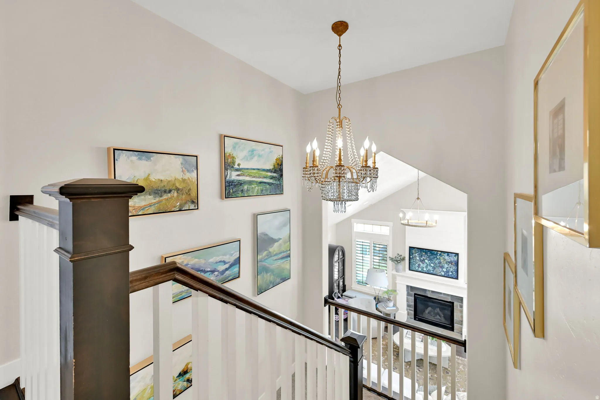 Multi-level interior featuring a decorative chandelier with crystal accents