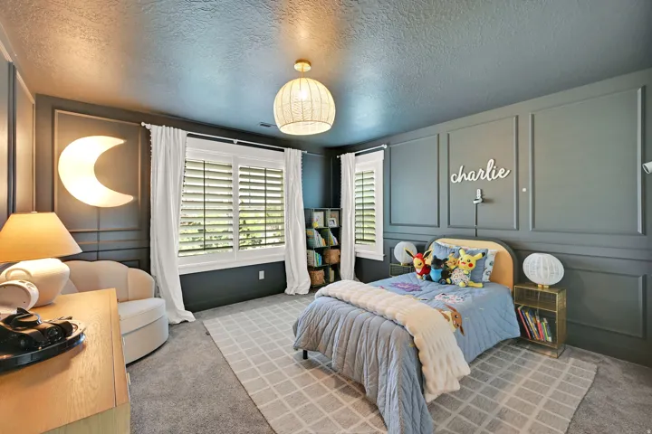 Well-appointed room featuring detailed wainscoting and a textured ceiling