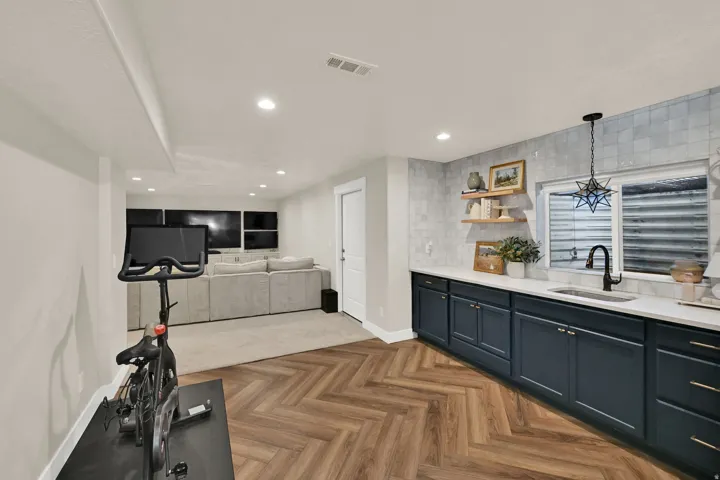 Lower-level space featuring wood-finish flooring in a herringbone pattern