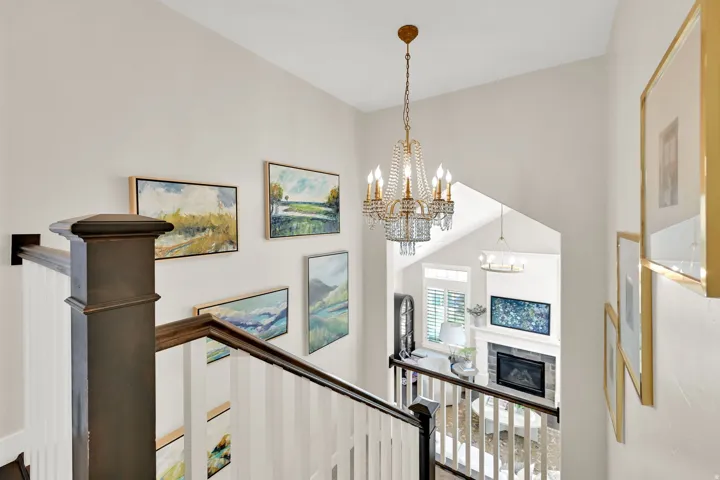 Multi-level interior featuring a decorative chandelier with crystal accents