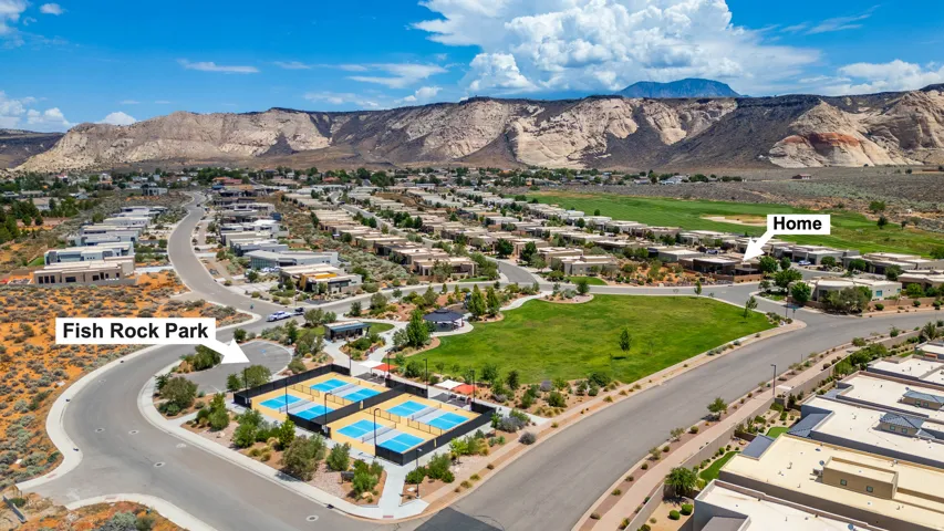 Aerial perspective showcasing a residential community with contemporary architecture set against a mountainous backdrop