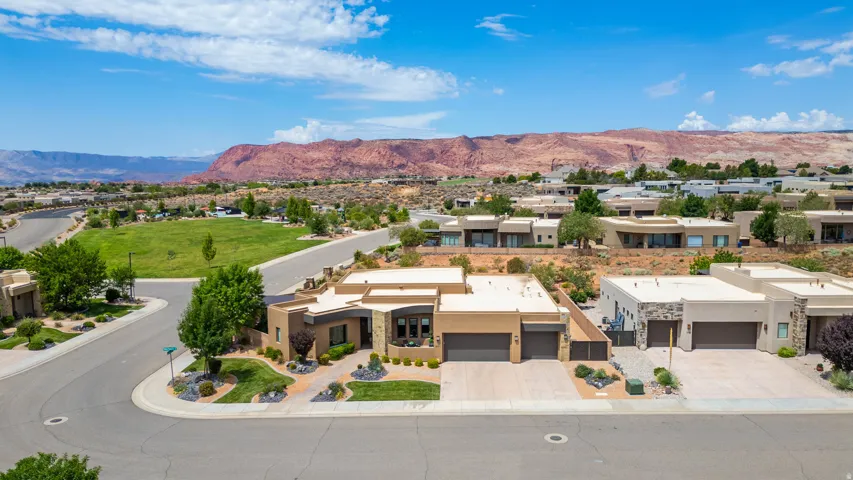 Modern desert architecture with flat rooflines, integrated two-car garages, and stucco exteriors