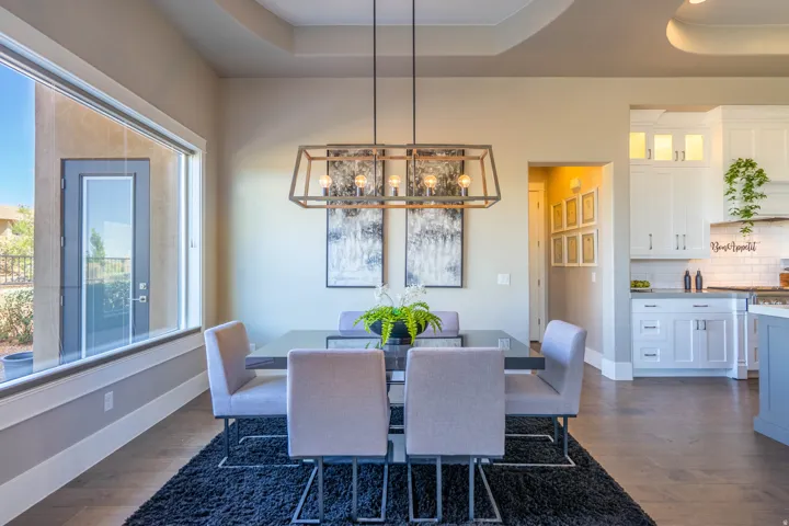 Dining area featuring a tray ceiling, a large picture window, and wood-finish flooring