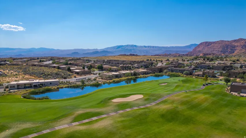Expansive golf course with a central water feature, surrounded by residential properties