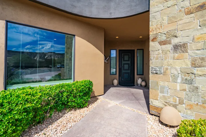 Contemporary exterior featuring a stone facade and stucco finishes