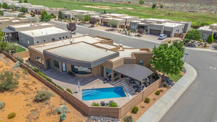 Contemporary stucco residence featuring a private swimming pool, covered patio, and desert landscaping