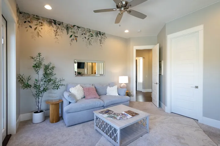 Spacious room featuring a decorative accent wall, recessed lighting, and a ceiling fan