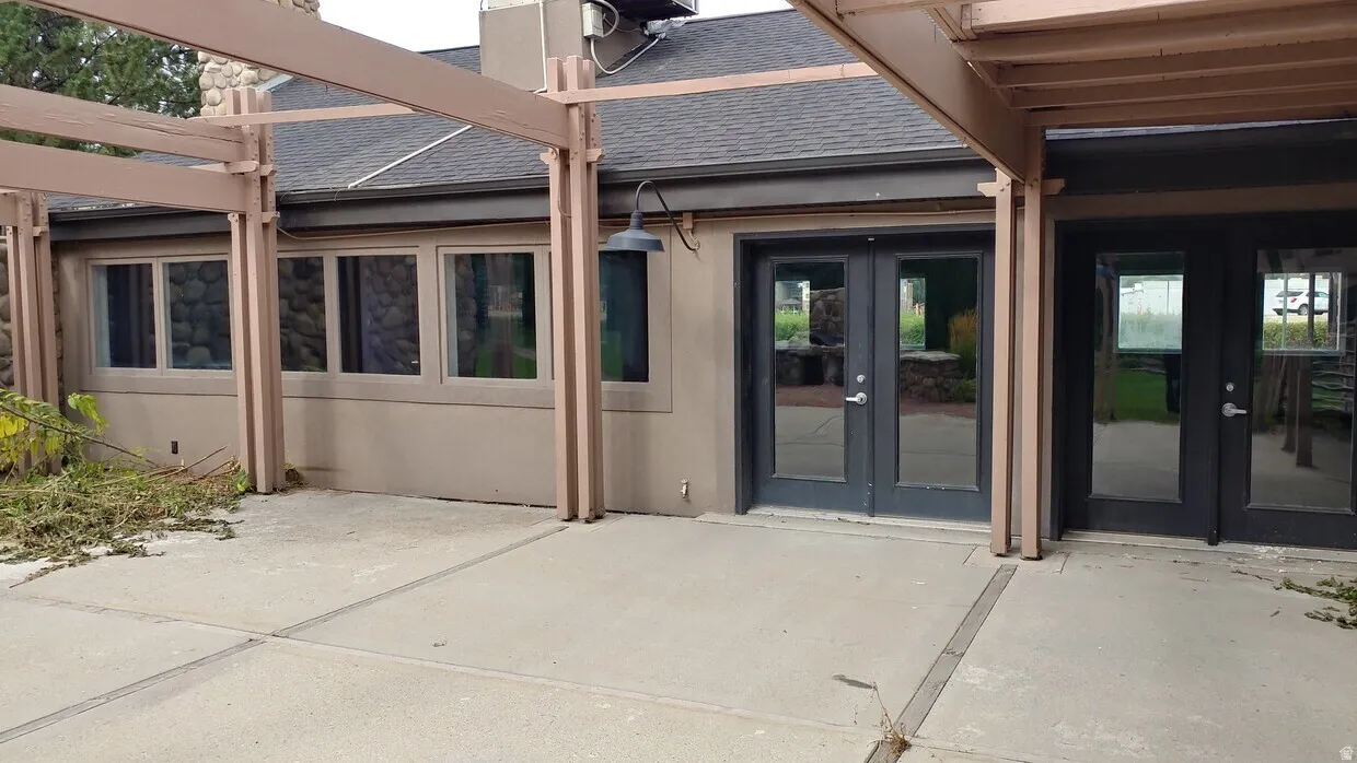 Concrete patio area with a pergola structure