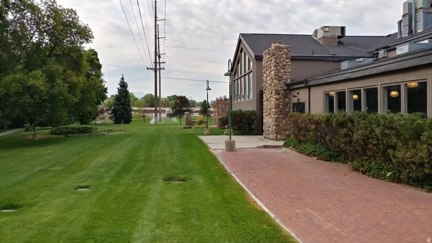 Exterior facade featuring a pitched roof, stone chimney, and multiple large windows