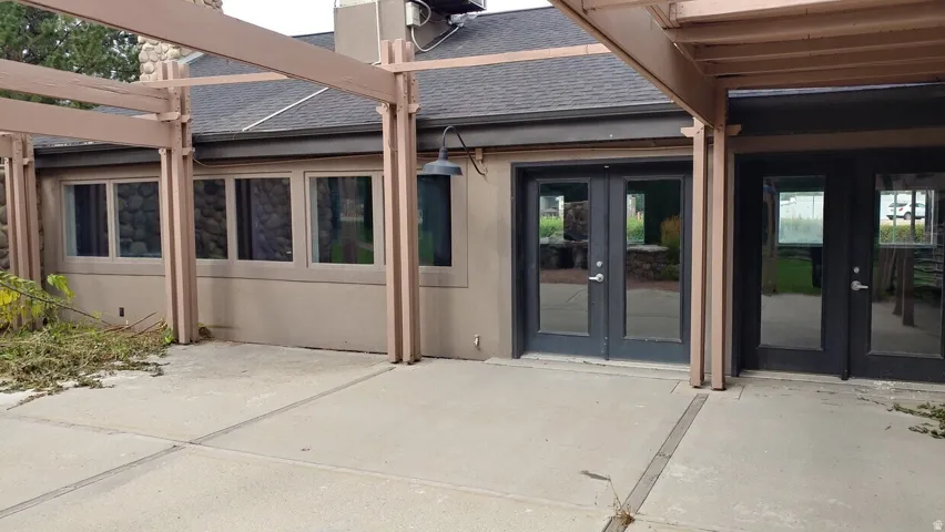 Concrete patio area with a pergola structure