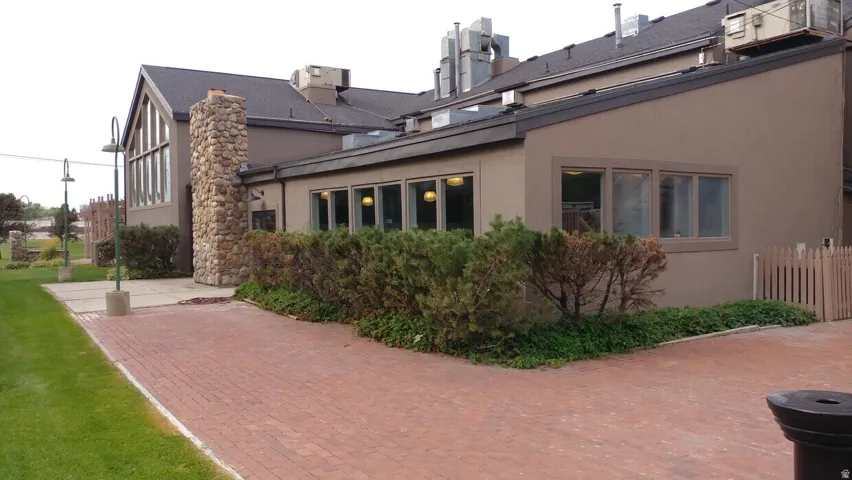 Exterior featuring a prominent stone facade element and a large window wall