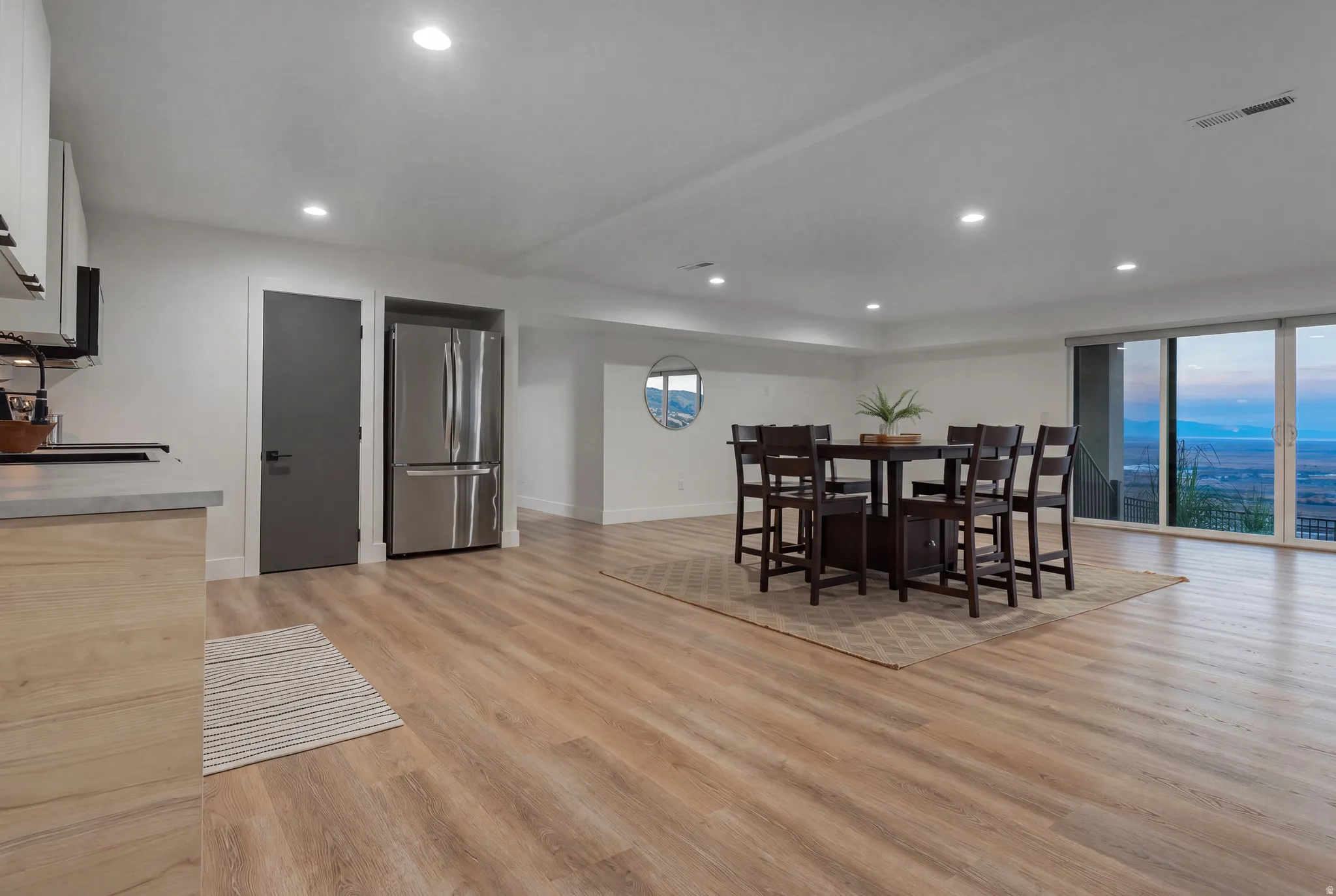 Open-concept living space with light wood-finish flooring