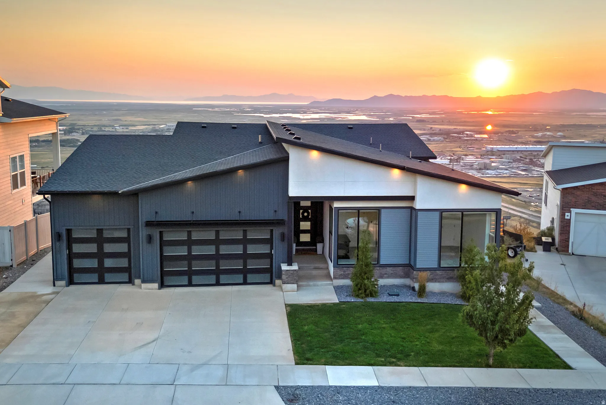 Modern architectural design featuring a multi-tone exterior with dark vertical siding and white stucco accents