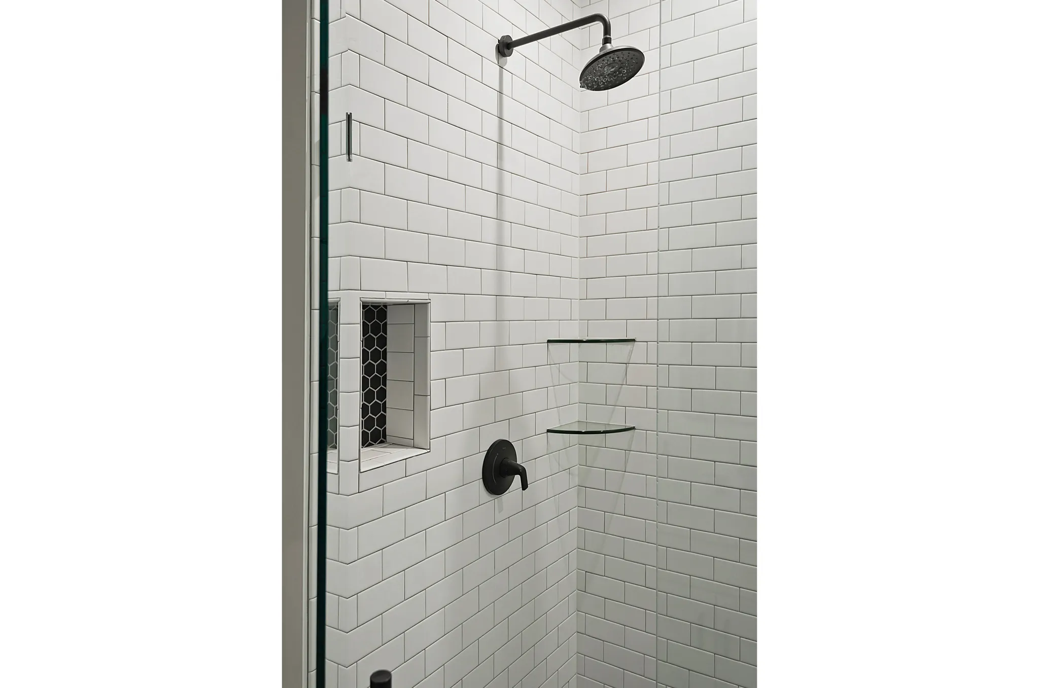Shower enclosure with white subway tile, a dark-finish rainfall showerhead, and a dark-finish shower control