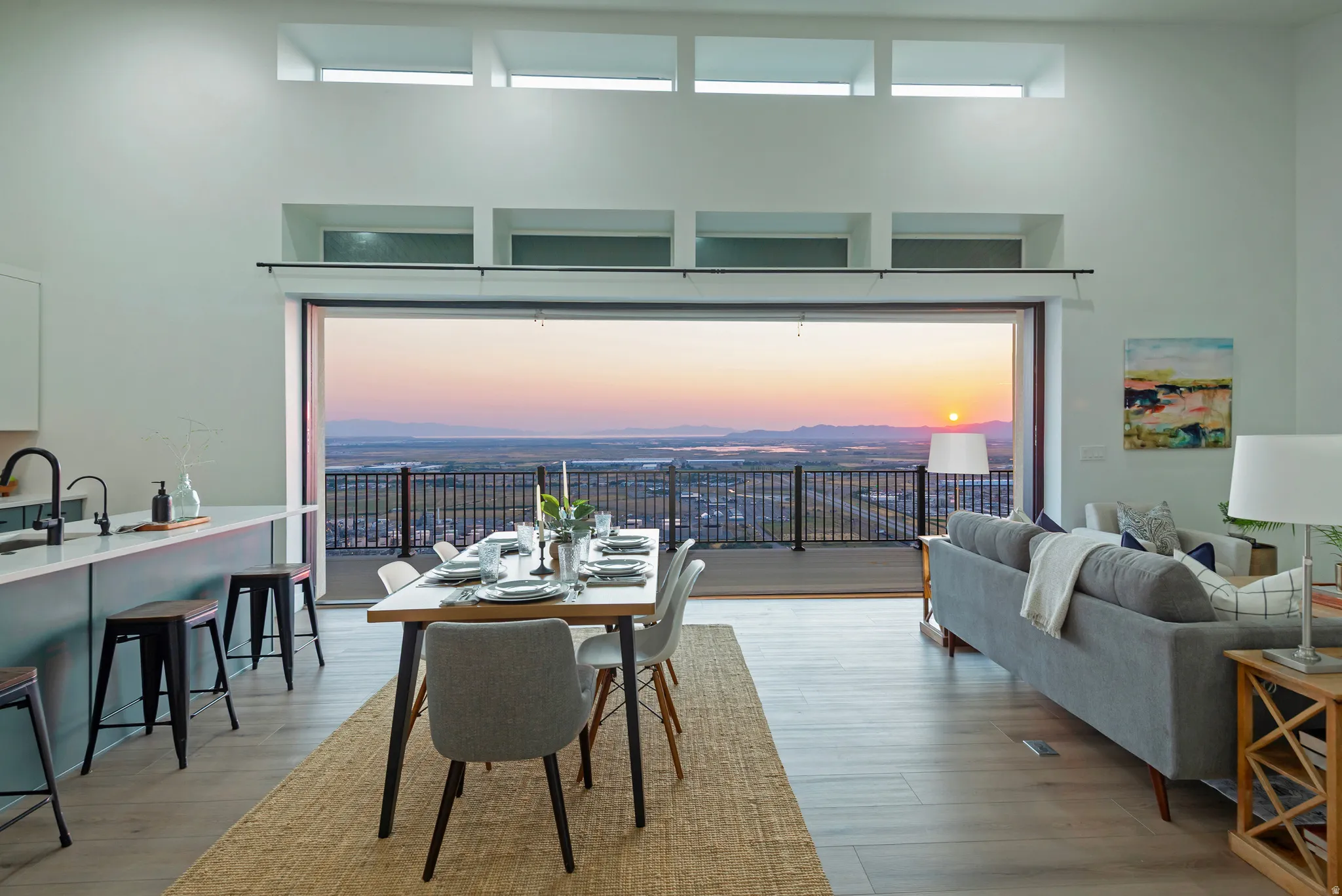 Open-concept living space featuring a wide-span sliding glass door opening to a private deck