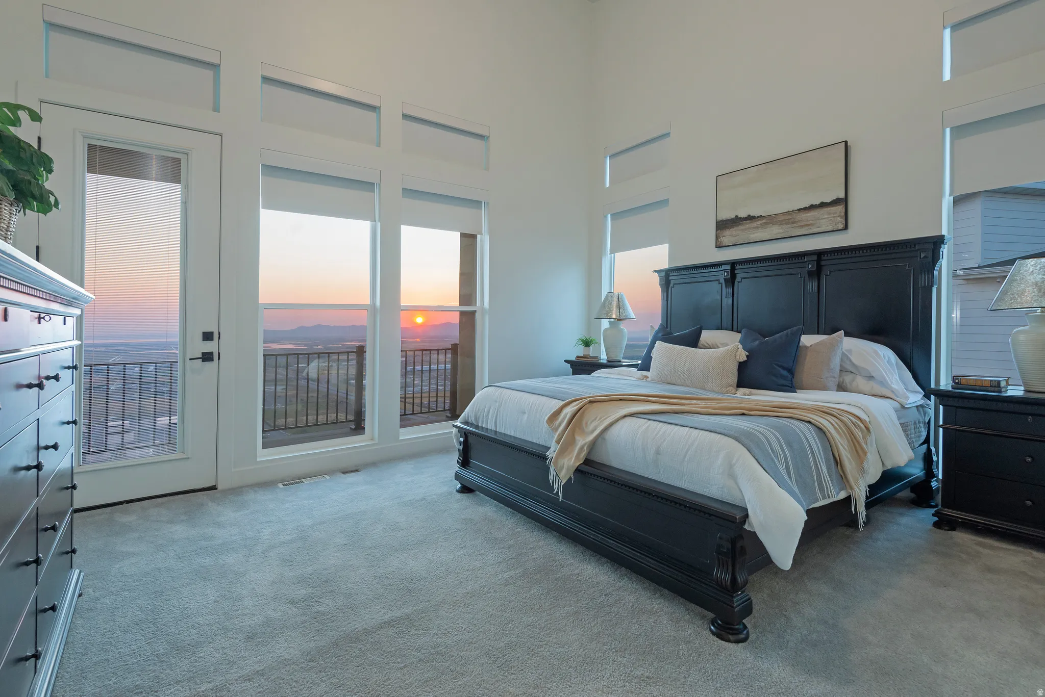 Spacious room featuring a wall of windows and an exterior door providing outdoor access