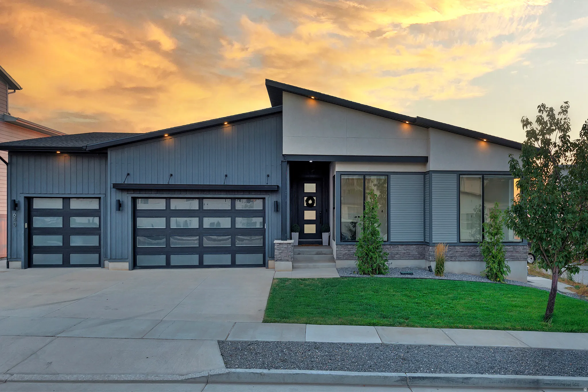 Contemporary exterior showcasing a multi-pitched roofline and mixed material facade