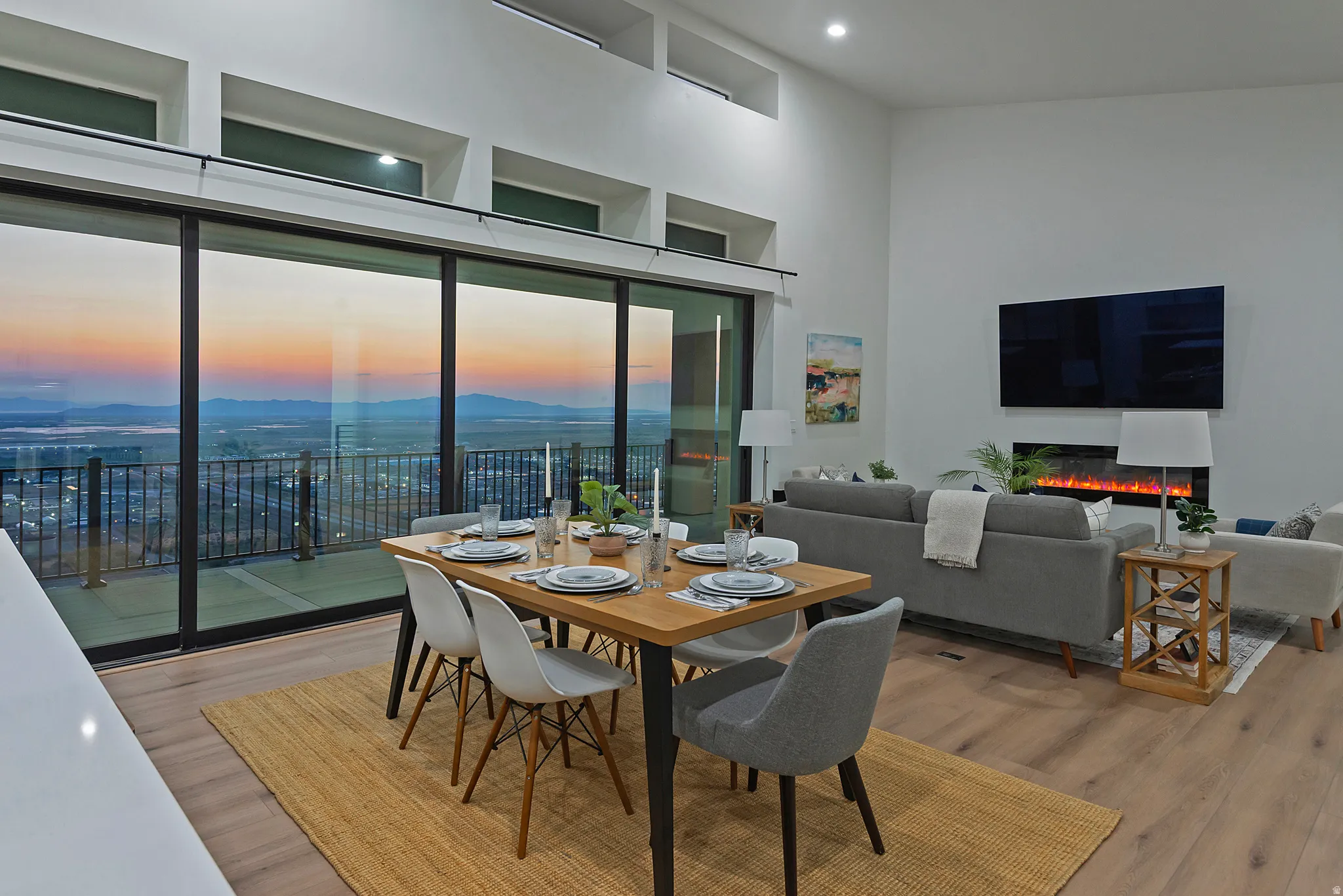 Open-concept living area with soaring ceilings and wood-finish flooring