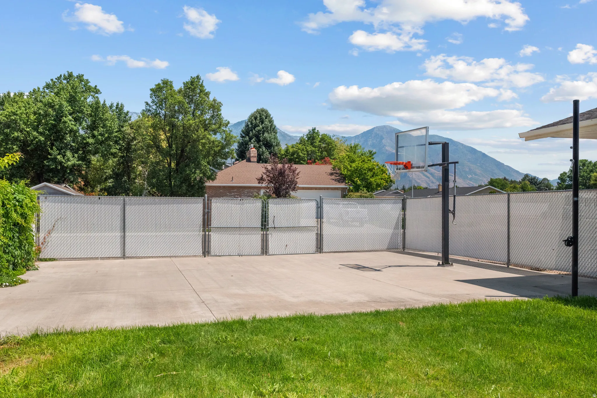 Expansive concrete patio with a mounted basketball hoop
