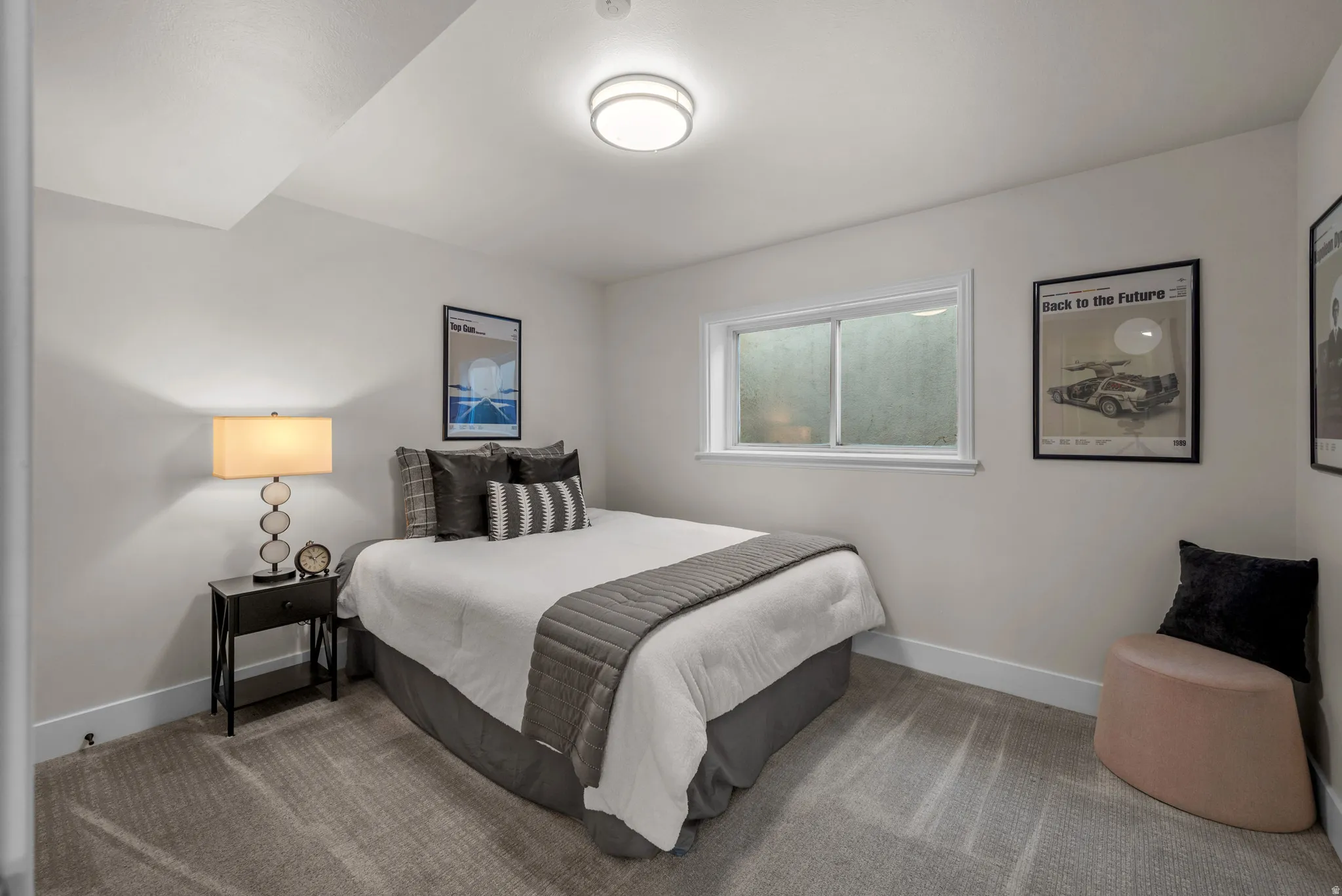 Bedroom featuring light gray wall paint, a single window, and plush carpet flooring