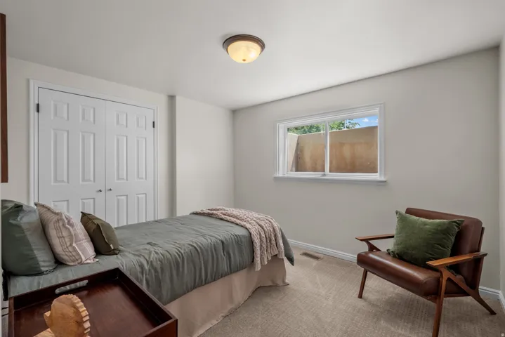 Neutral wall finishes complement the textured carpeting