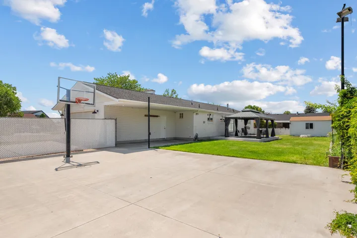 Expansive concrete patio with a covered carport