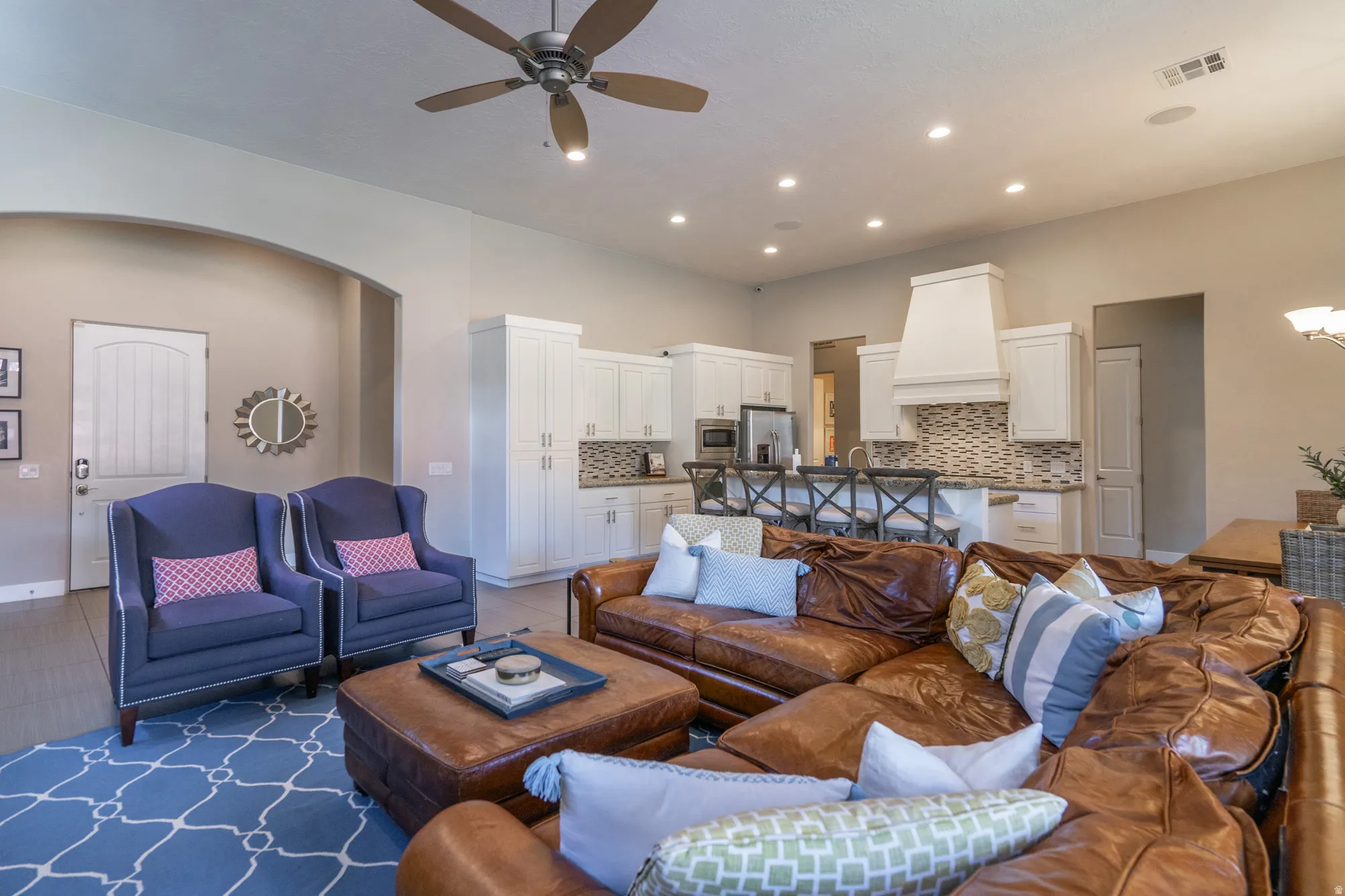 Open-concept living space featuring recessed lighting, a ceiling fan, and light wood-finish flooring