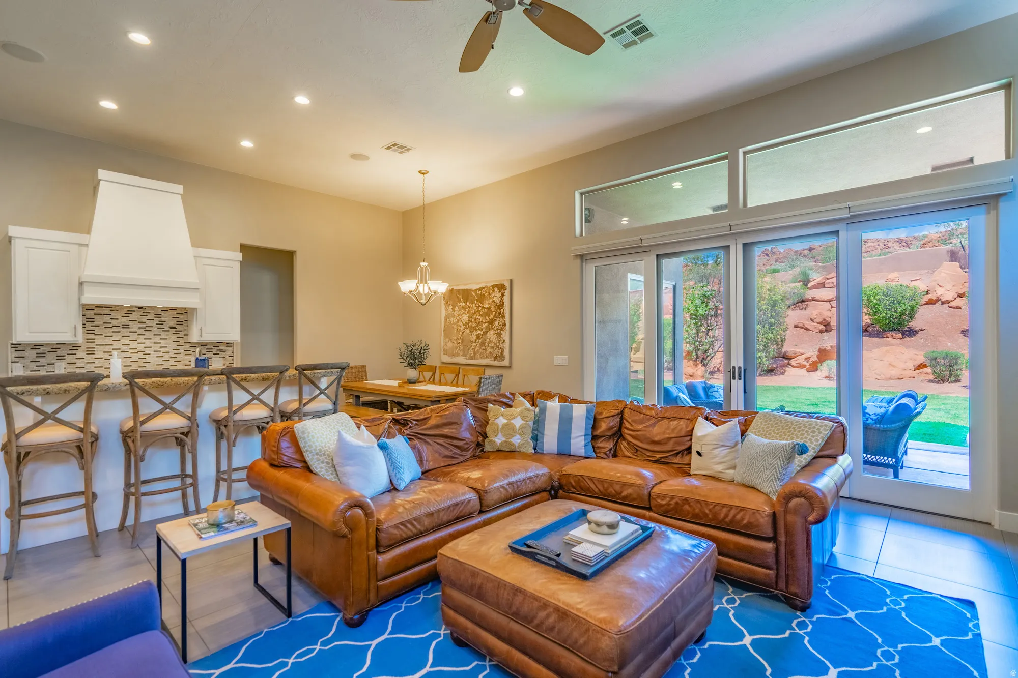Open-concept living space featuring high ceilings, recessed lighting, and a neutral color palette