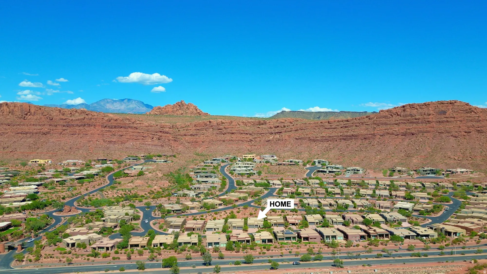 Desert landscape community framed by red rock mountains