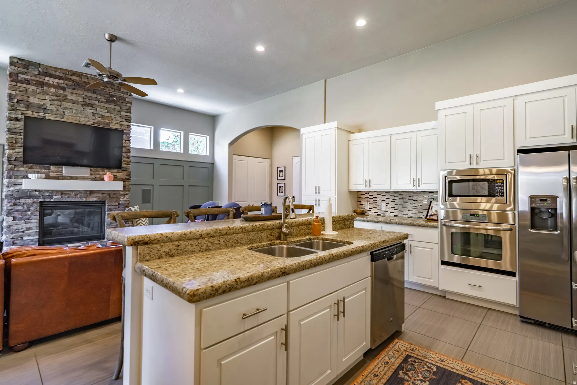 Spacious kitchen with light-finish cabinetry, stainless steel appliances, and a double basin sink