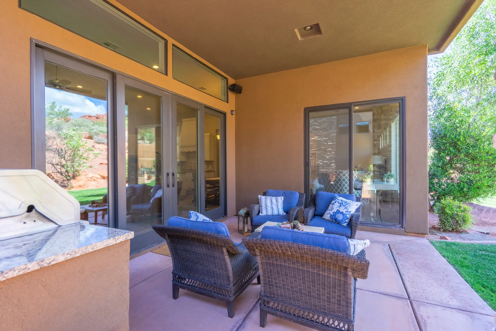 Covered patio featuring an integrated built-in grill with a stone-finish countertop