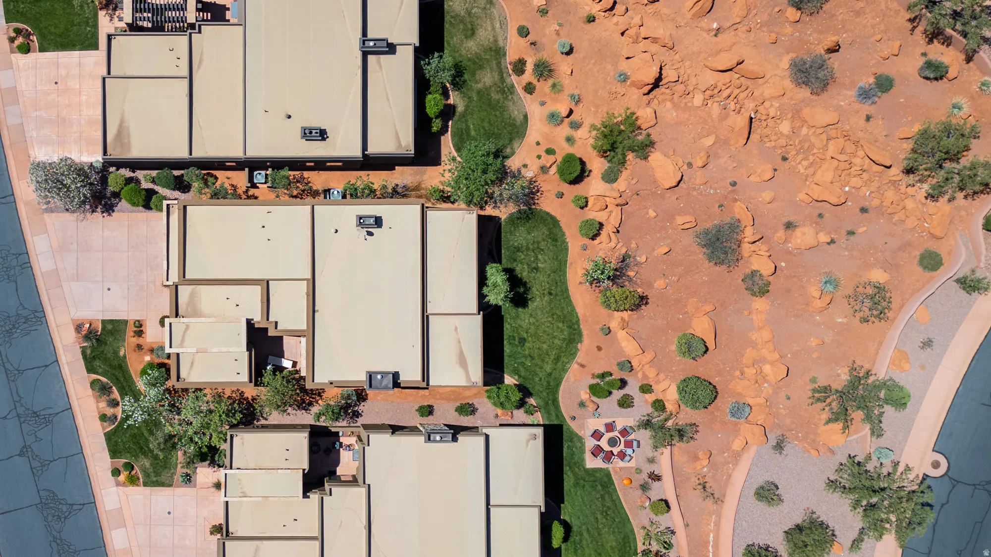 Aerial perspective showcasing multiple residential structures with flat roofs