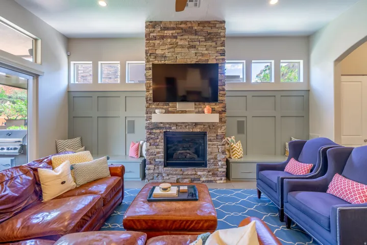 Stacked stone fireplace with a white mantel and recessed hearth