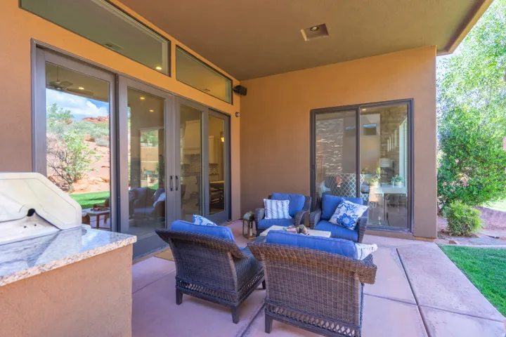 Covered patio featuring an integrated built-in grill with a stone-finish countertop