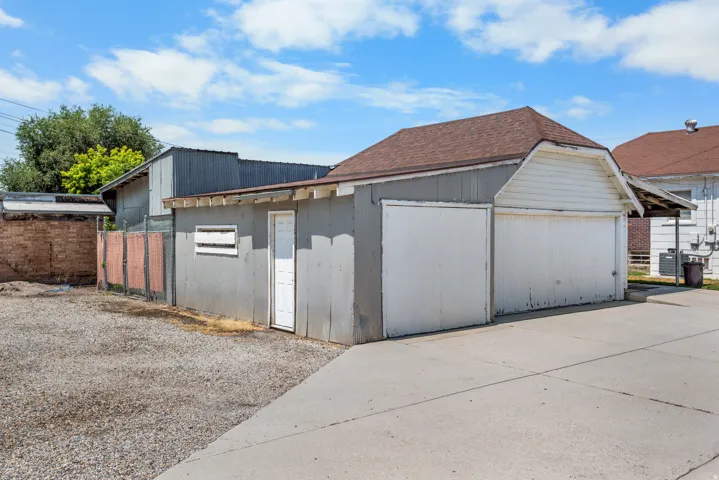 Detached garage structure featuring dual overhead doors and an additional side entry door