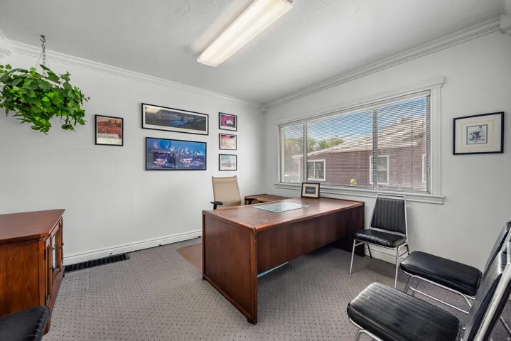 Bright room featuring crown molding and a large window with white blinds