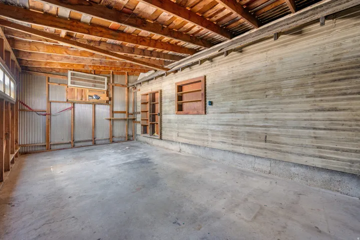 Exposed wood beam ceiling over a concrete floor